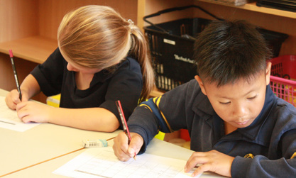 two kids writing two kids writing
